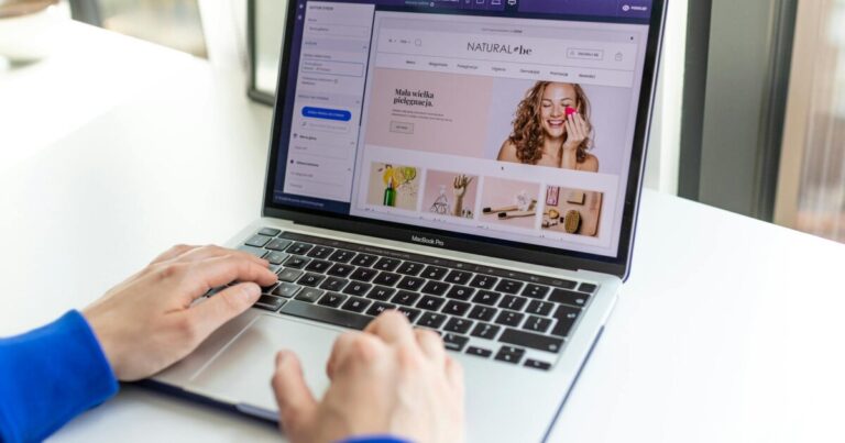 Hands typing on a laptop with an e-commerce website open, showcasing online shopping.