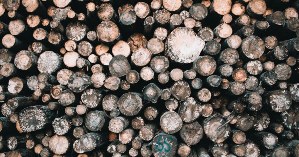 High angle view of stacked firewood logs ready for use, showcasing natural textures.