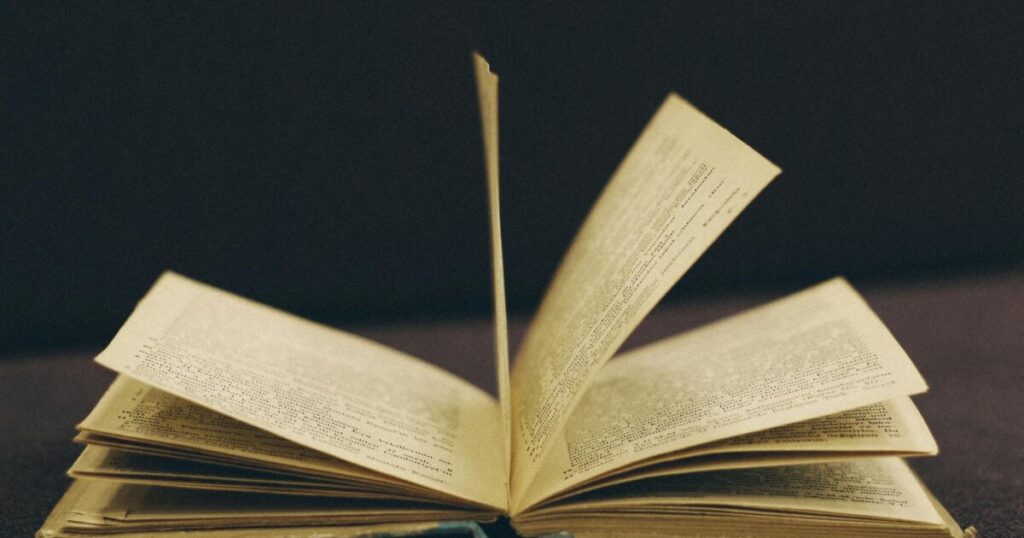 Close-up of an open vintage book with pages mid-turn, offering a nostalgic and literary feel.