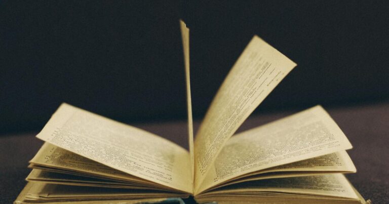 Close-up of an open vintage book with pages mid-turn, offering a nostalgic and literary feel.