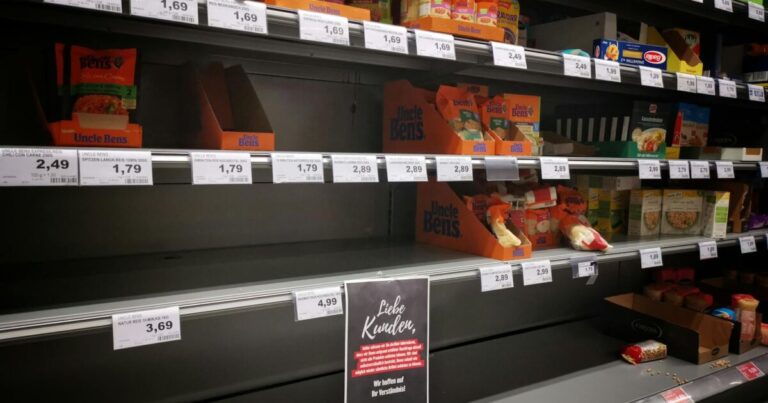Half empty shelves with assorted products in jars and containers in supermarket during quarantine