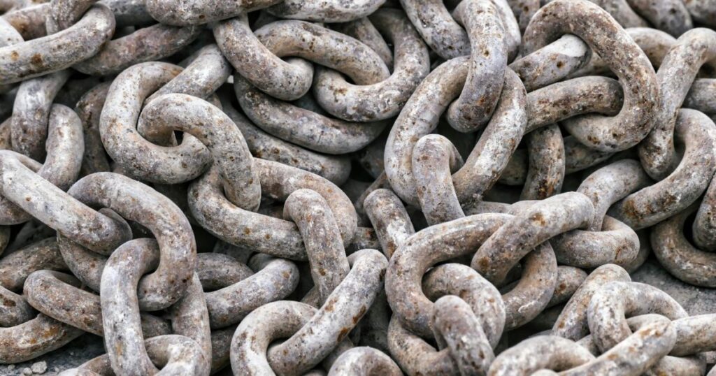 Detailed close-up of tangled rusty metal chains showing intricate texture.