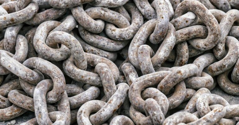 Detailed close-up of tangled rusty metal chains showing intricate texture.