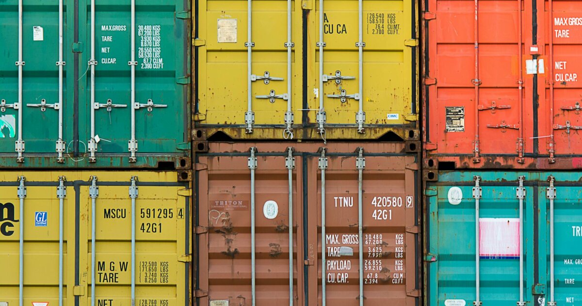 Vibrant cargo containers stacked in a shipping yard highlighting global trade.