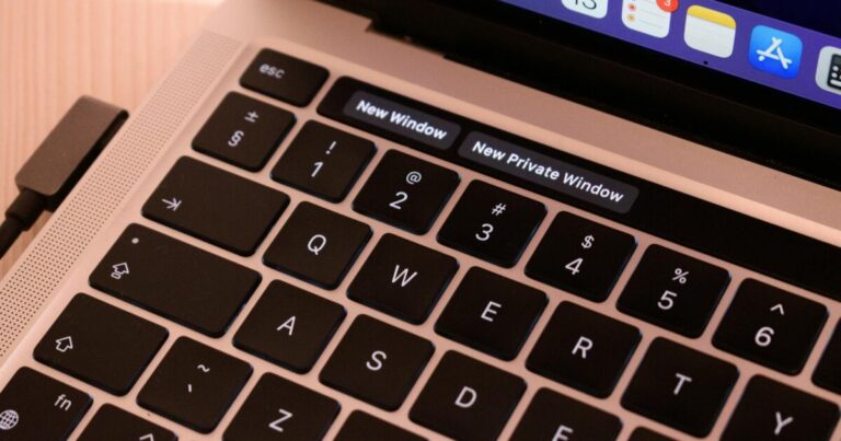 A detailed view of a laptop keyboard with browser tabs open, highlighting 'New Window' and 'New Private Window'.