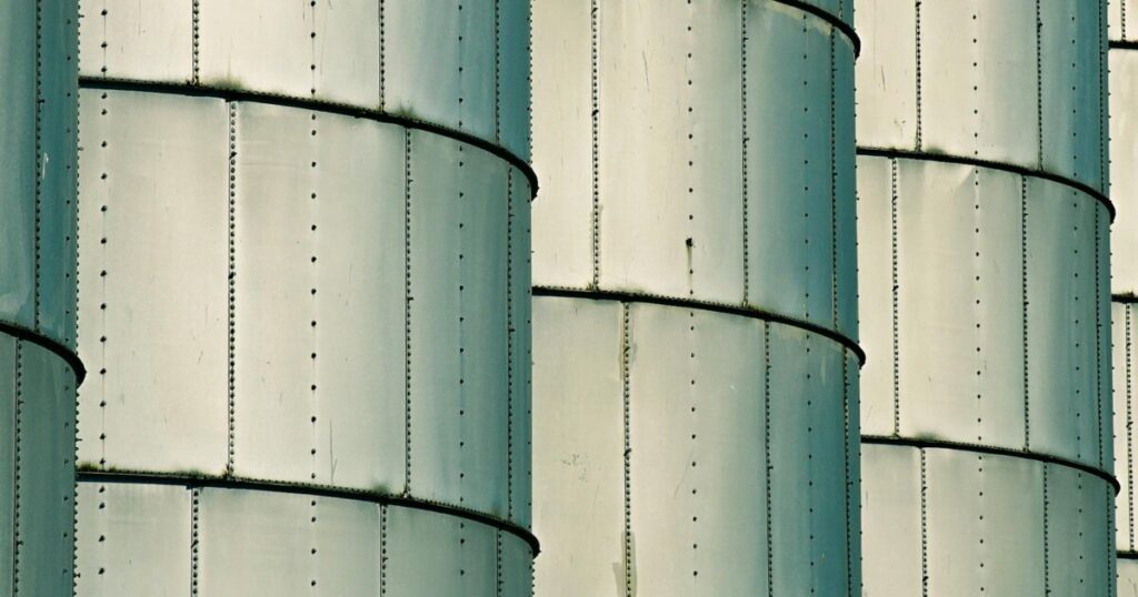 Detailed view of metal silos showcasing industrial architecture and pattern repetition.