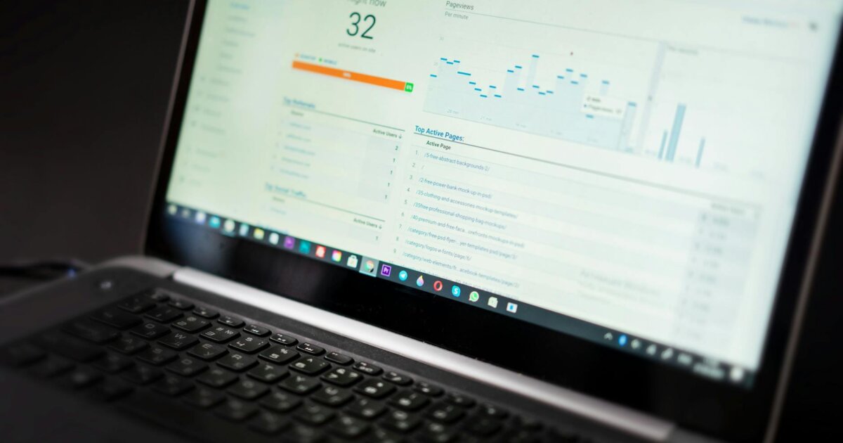 A laptop displaying an analytics dashboard with real-time data tracking and analysis tools.